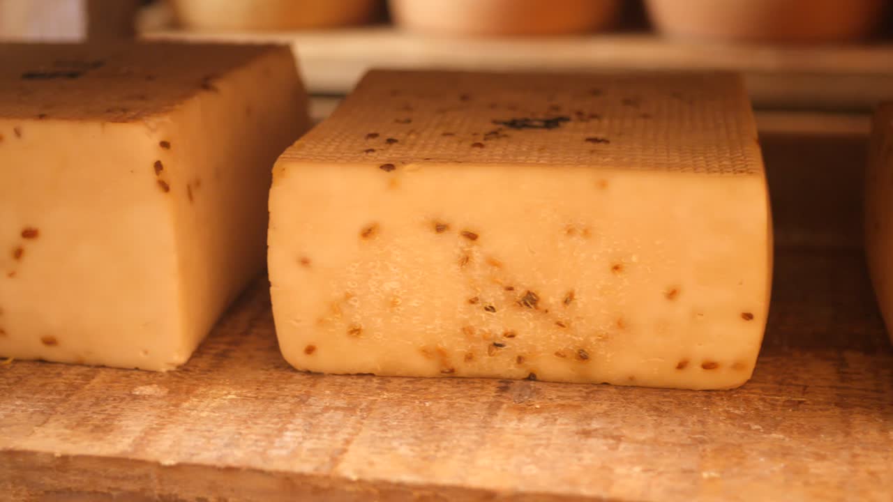 A detailed close-up of fresh, artisanal goat cheese, capturing its texture and natural form