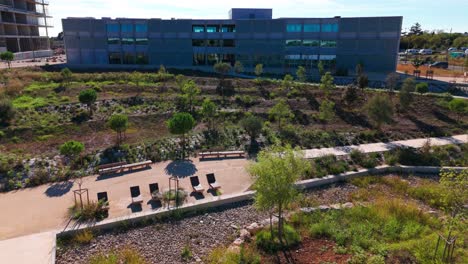 Drone-Progression:-Unveiling-the-Grey-Building-Amidst-Gardens