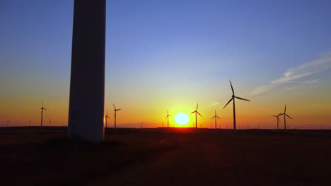 windmill turbines for electric power on the sunset. alternative energy