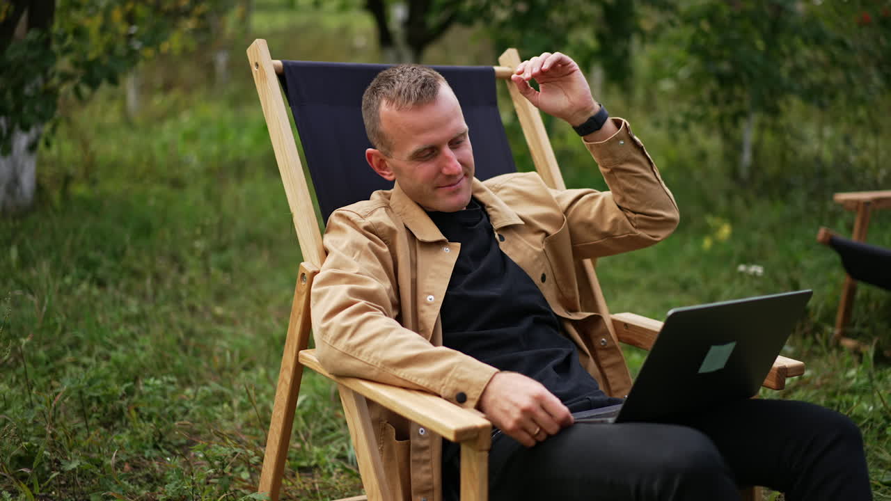 Man working on laptop in a garden