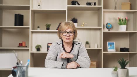 old-charismatic-woman-scolds-while-looking-at-the-camera-and-waving-and-gesturing-with-her-hands