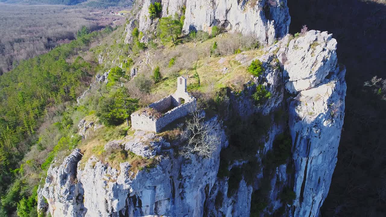 ruins of a church on a cliff, medieval town of Motovun. Aerial pedestal shot