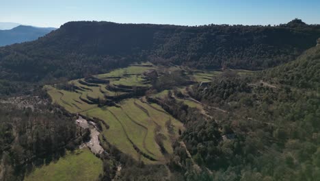 The-scenic-terraced-landscape-in-tavertet-region,-barcelona,-on-a-clear-sunny-day,-aerial-view