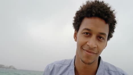 front view of african american man standing on the beach 4k