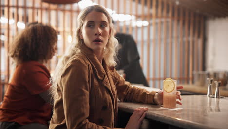 woman waiting at a bar counter