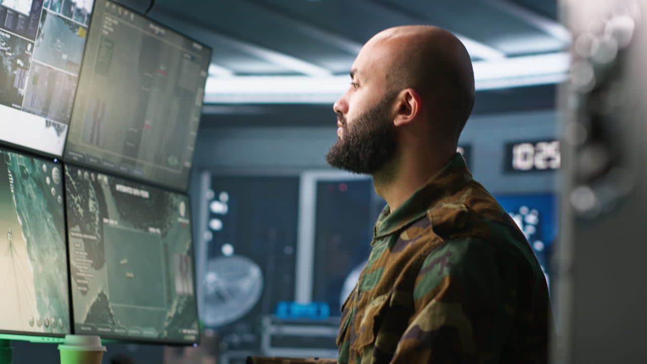 Portrait of military agent working in control room, analyzing aerial data