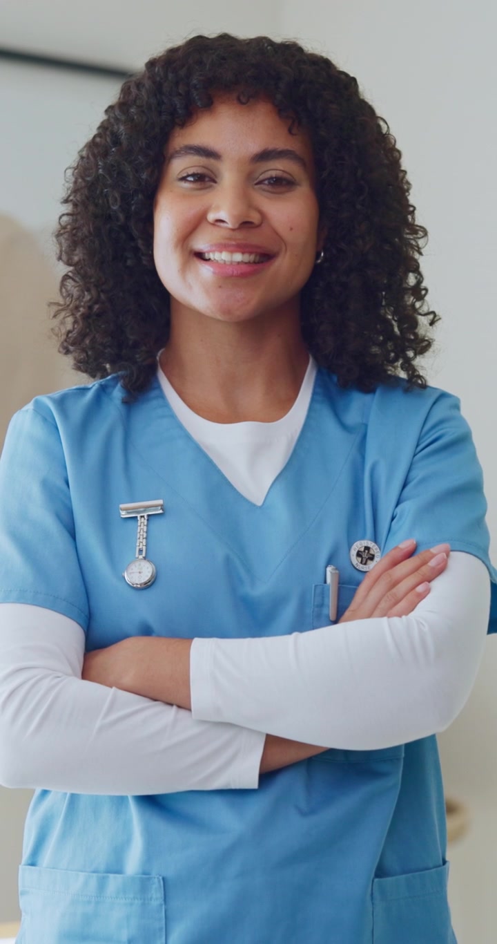 Smiling Female Nurse Standing with Arms Crossed