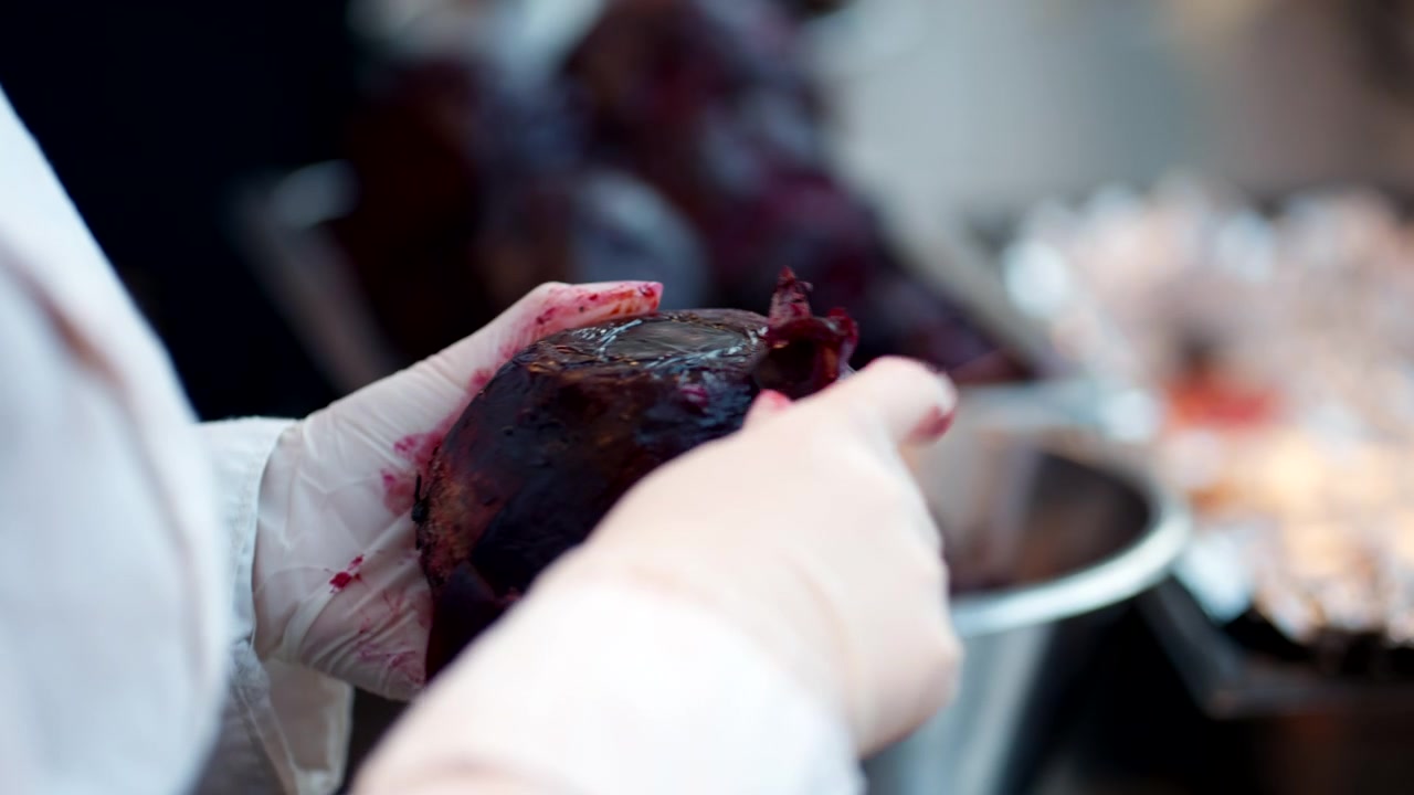Hands Peeling Beet With Paring Knife. Preparing Baked Beets In Kitchen. closeup shot