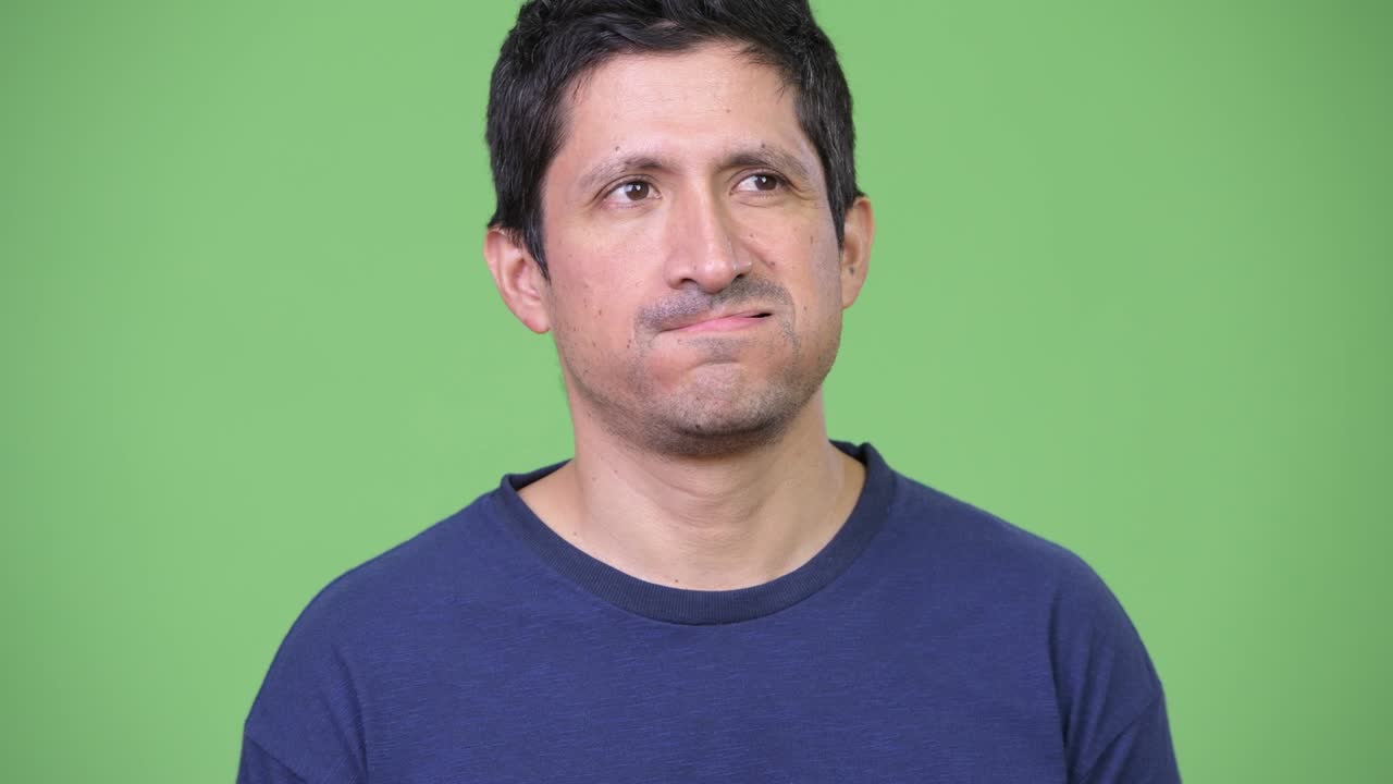 Annoyed Hispanic man looking bored