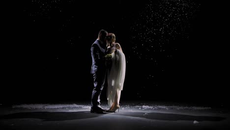 couple kissing in winter snow