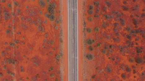 australian outback desert road top down aerial with red dirt, near marla, south australia