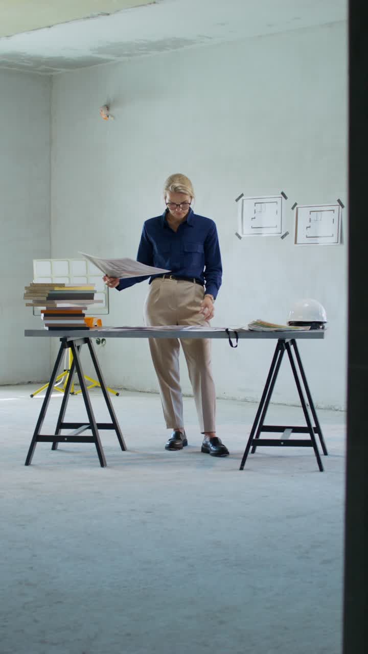 Architect reviewing building plans at construction site
