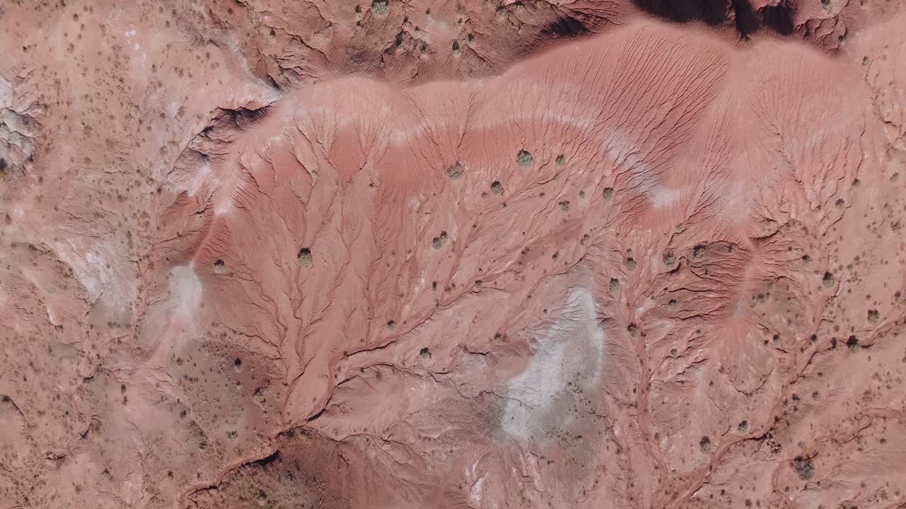 Aerial view of New Mexico desert, showcasing abstract red rock textures