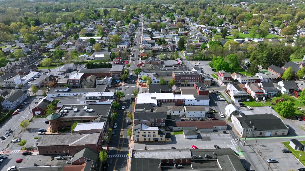 Drone shot of small american town with main street during sunny day in Spring Season
