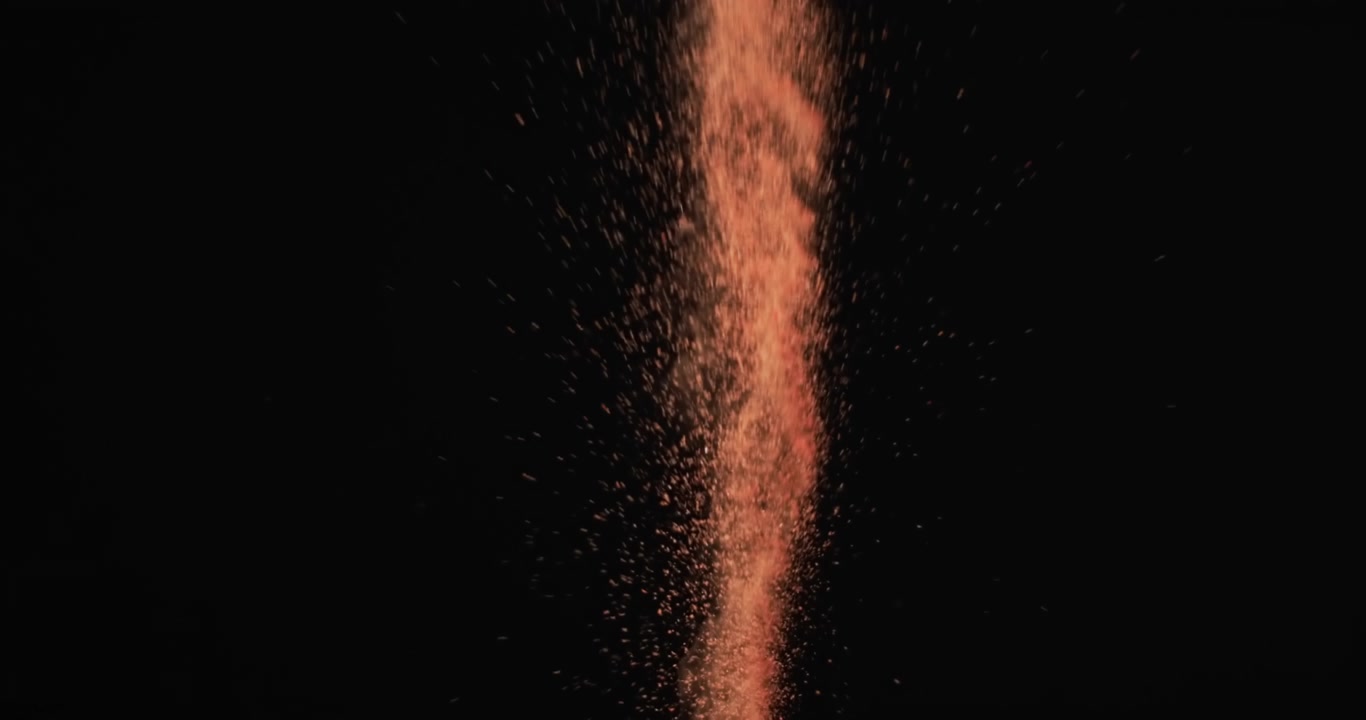 Video di granelli di sabbia lanciati in aria e spazio per il testo su sfondo nero.