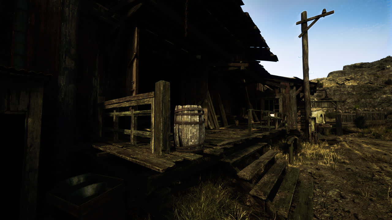 Old wooden structure with barrels and rugged terrain in a quiet setting