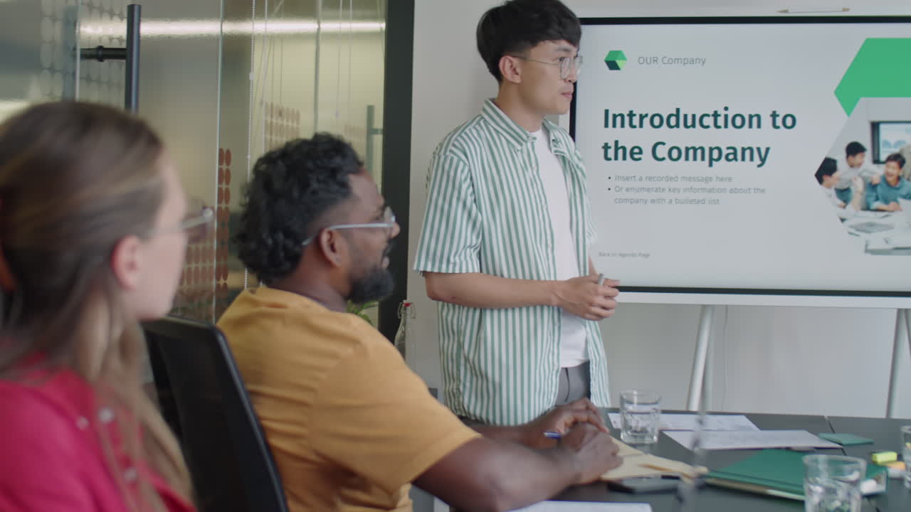 Young Asian Man Giving Business Presentation on Team Meeting