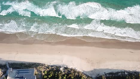 Drone-arial-high-over-blue-sandy-beach-on-the-great-ocean-road-on-sunny-summers-day