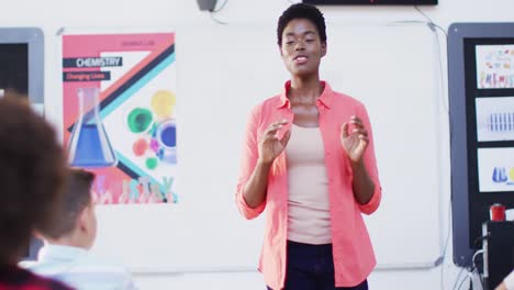 african american female teacher with diverse schoolchildren at classroom, slow motion