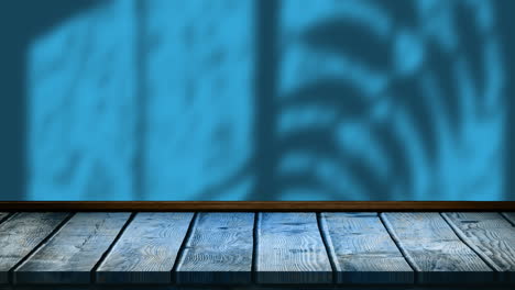 animación de hojas y sombras de ventanas sobre fondo azul y de madera