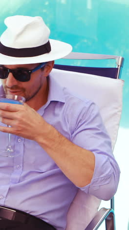 handsome man using tablet and drinking cocktail