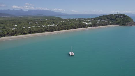 Barco-En-El-Océano-Sereno-De-La-Playa-De-Cuatro-Millas-En-Port-Douglas,-Queensland,-Australia---Toma-Aérea-De-Drones