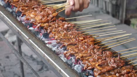 chicken satay (favorite food in indonesia) cooking process. grilled chicken over coals