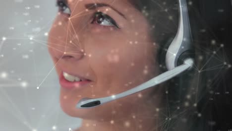 Animation-of-data-processing-over-businesswoman-using-phone-headsets