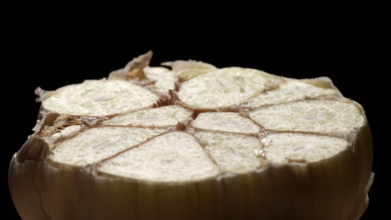 Close up macro view of a Garlic sliced through the middle, showing it's interior cooking concept