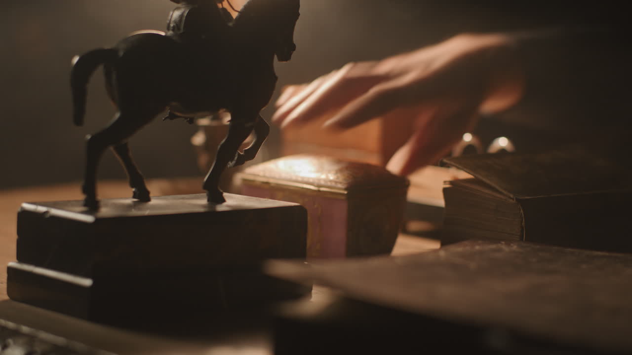 Older passionate man evaluates an old porcelain box