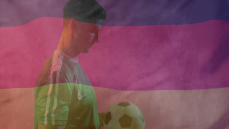 animation of flag of germany over caucasian male football player with ball