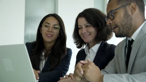 Cheerful-business-consultants-having-video-call-through-laptop