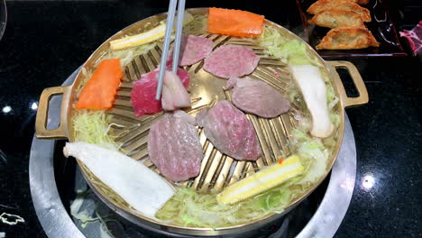 japanese cuisine jingisukan is a style of japanese cuisine that uses dome-shaped metal skillet to cook food similar to barbecue, in which items of food on skewers are slow-grilled over hot plate