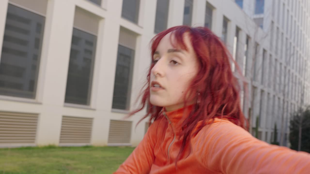Redhead dancer performing modern dance moves outdoors