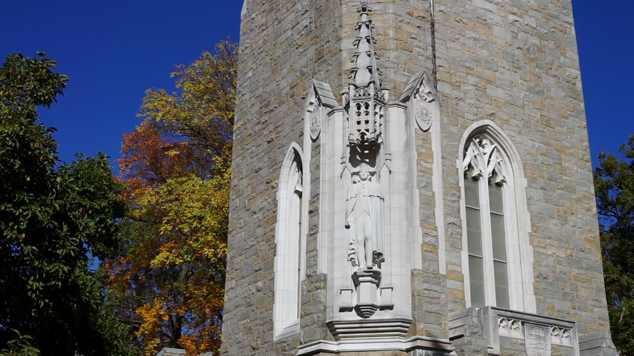 Bell tower with gothic window and statue of George Washington.