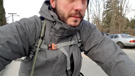 man on bike ride selfie while cruising through a busy road in the city