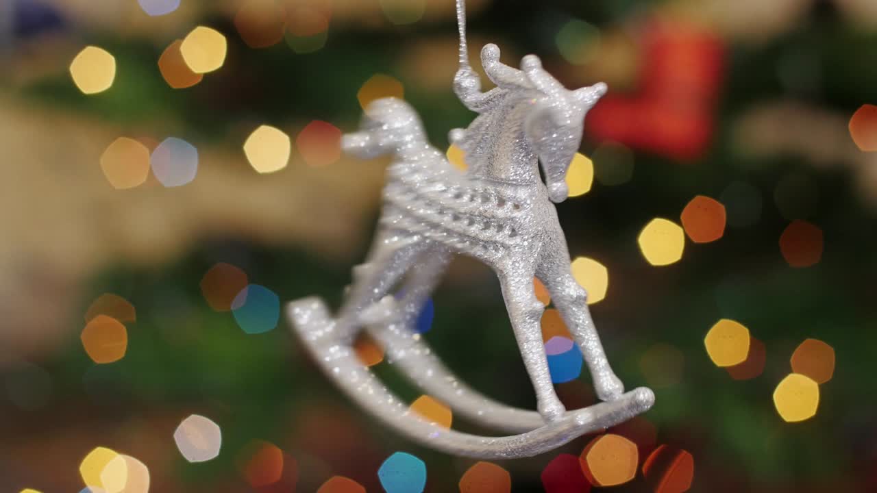 Christmas horse toy rotates at background bokeh