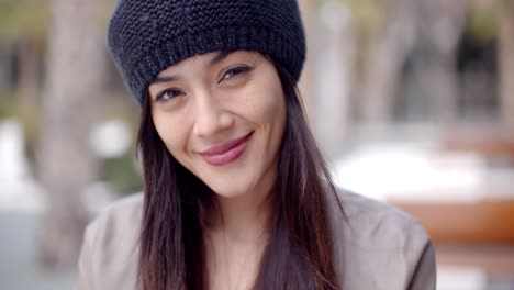 pretty thoughtful young woman in a woolly cap