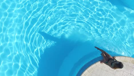 woman relaxing by poolside