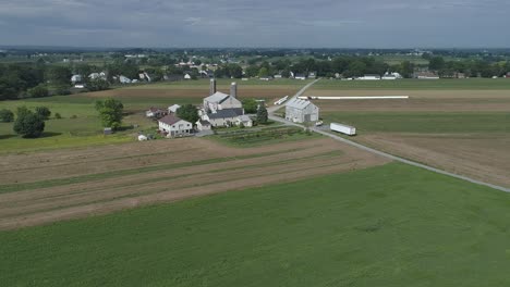 aerial view of amish farmer seeding his field with 6 horses