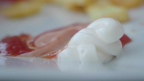 close-up of french fries with mayonnaise and ketchup