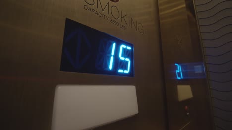 close up on elevator floor numbers as they ascend