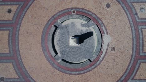 Top-down-view-from-drone-as-it-descends-over-obelisk,-landmark,-Muizenberg,-South-Africa