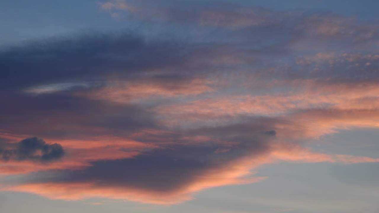 time lapse of clouds lit by the setting sun