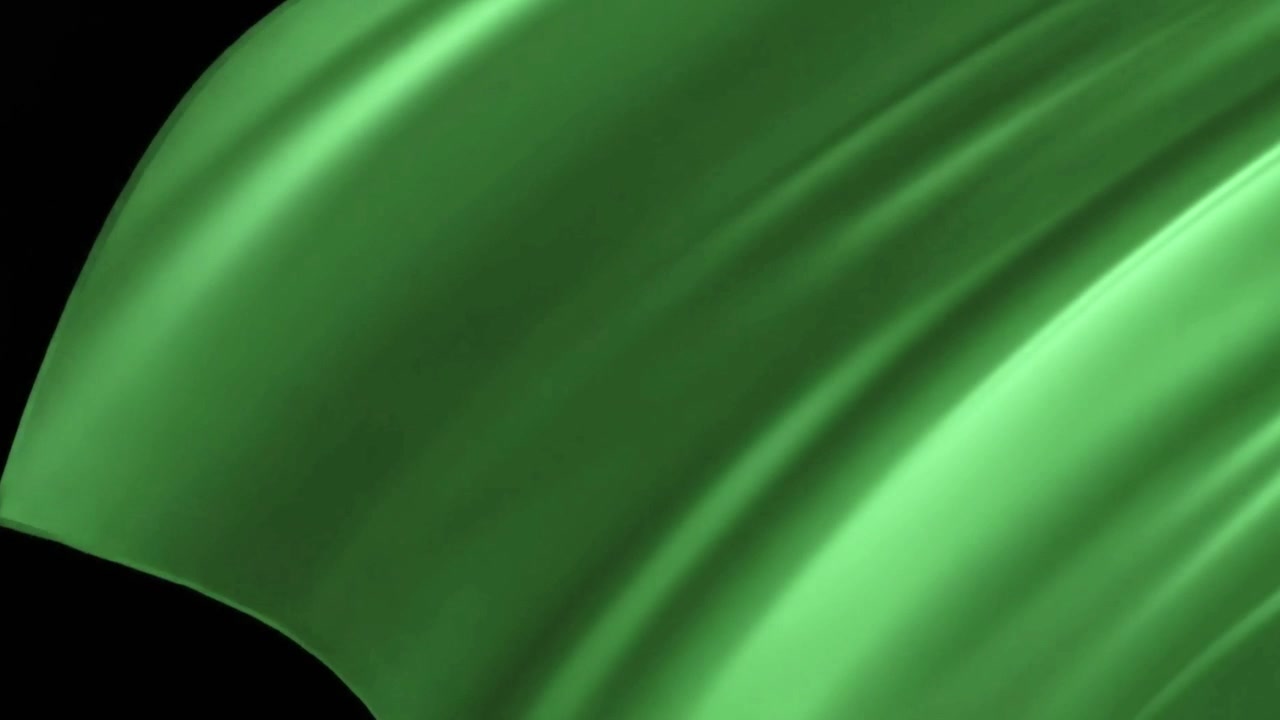 Tessuto di seta verde che ondeggia e si dispiega su sfondo nero