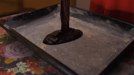 pouring dark chocolate cake