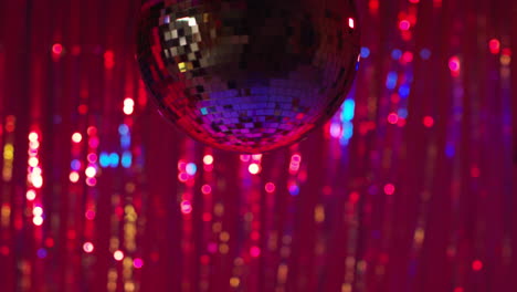 close up of mirrorball in night club or disco with flashing strobe lighting and sparkling lights in background 4