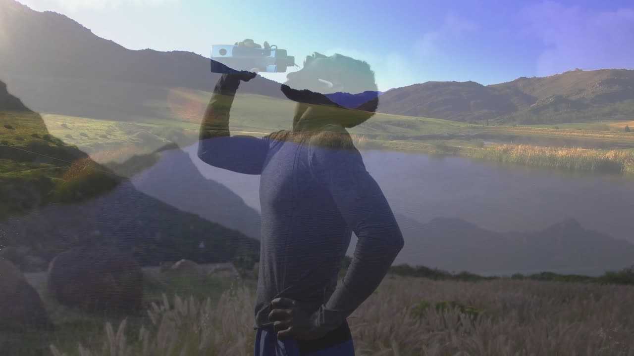 Male athlete pausing hydration in outdoor field, featuring animated health data and hydration chart