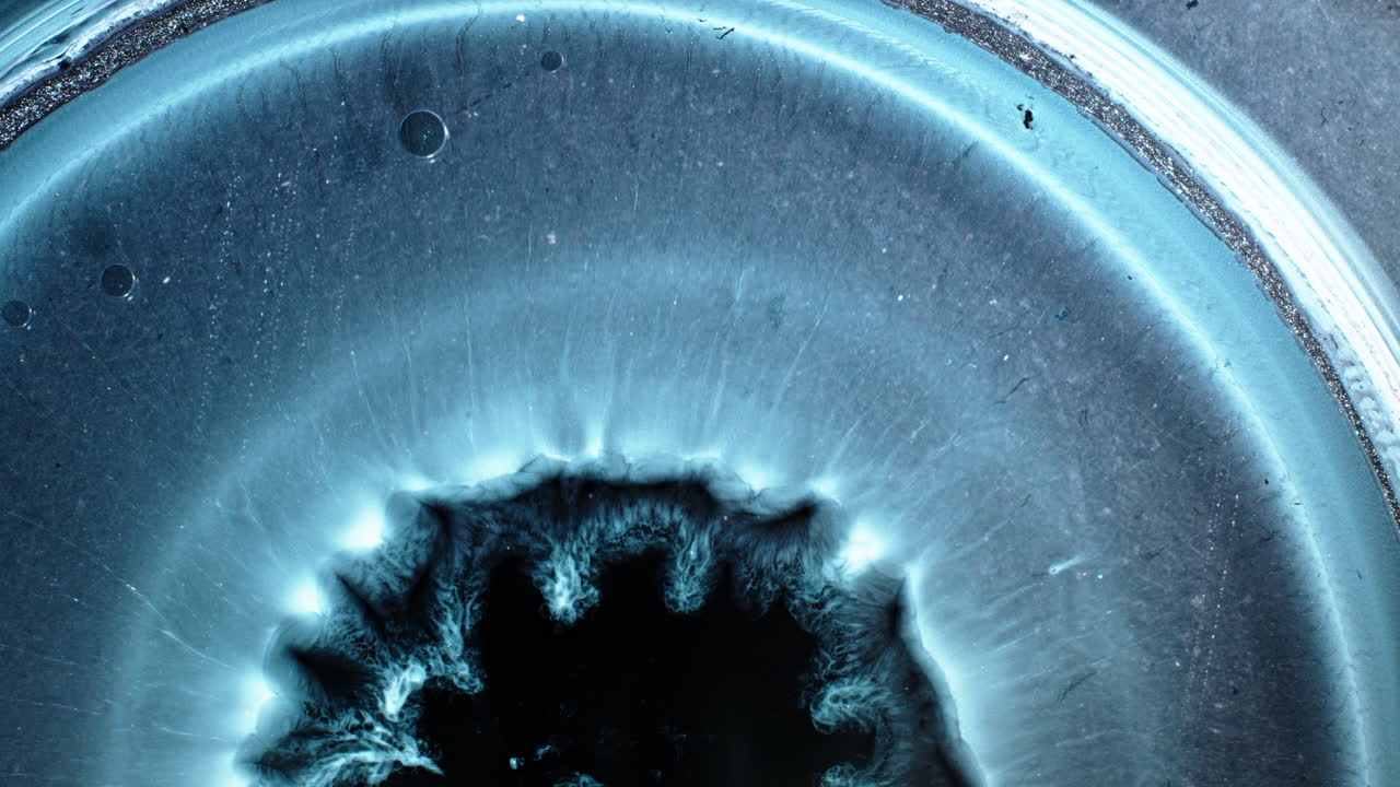 Macro view of substances mixing, creating vibrant textures and patterns