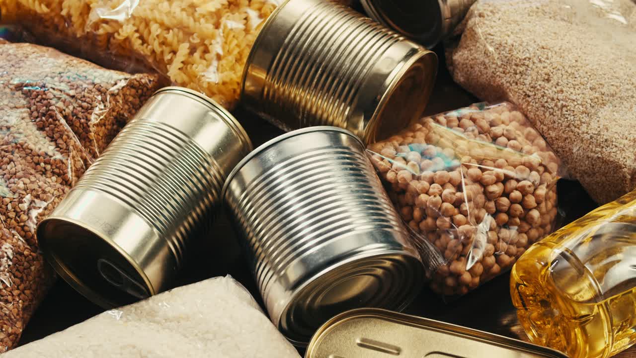 Canned cereals beans fish and vegetables, an assortment of processed foods, supermarket cart online shopping, delivery.